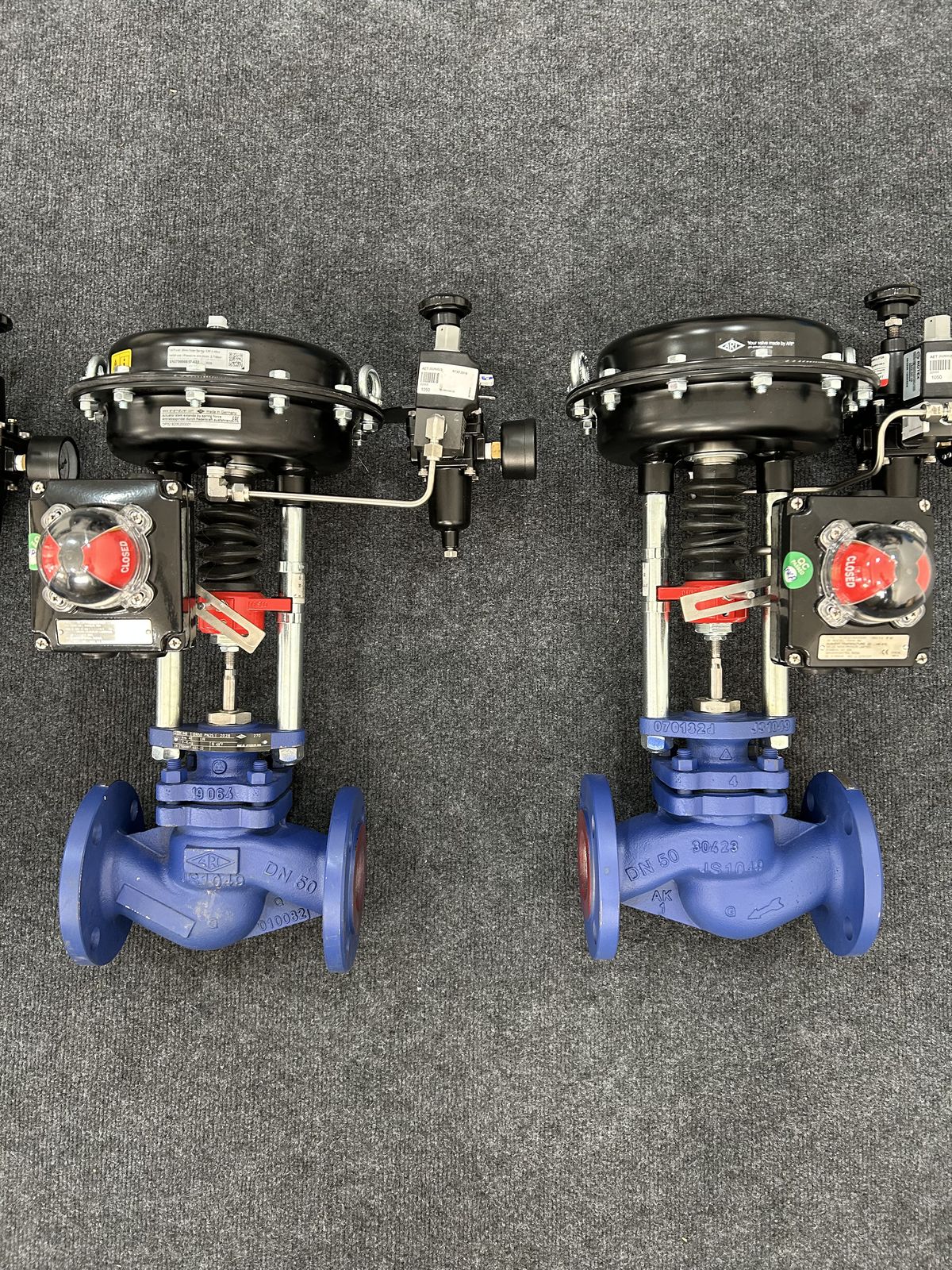 Two assembled ARI-STEVI Smart control valves showing the pneumatic actuator, limit switch enclosure and solenoid valve, closed position