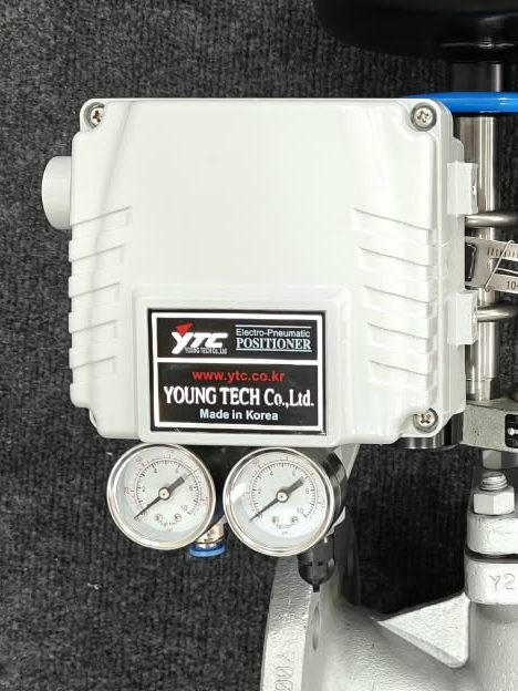 Close-up of the YTC electro-pneumatic positioner (Young Tech Co., Korea) with its supply and output air pressure gauges and PU tubing